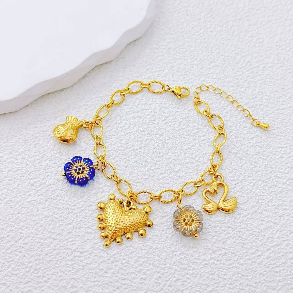 Bracelet doré charms varié acier inoxydable motif symbolique - Bijoux Bravo